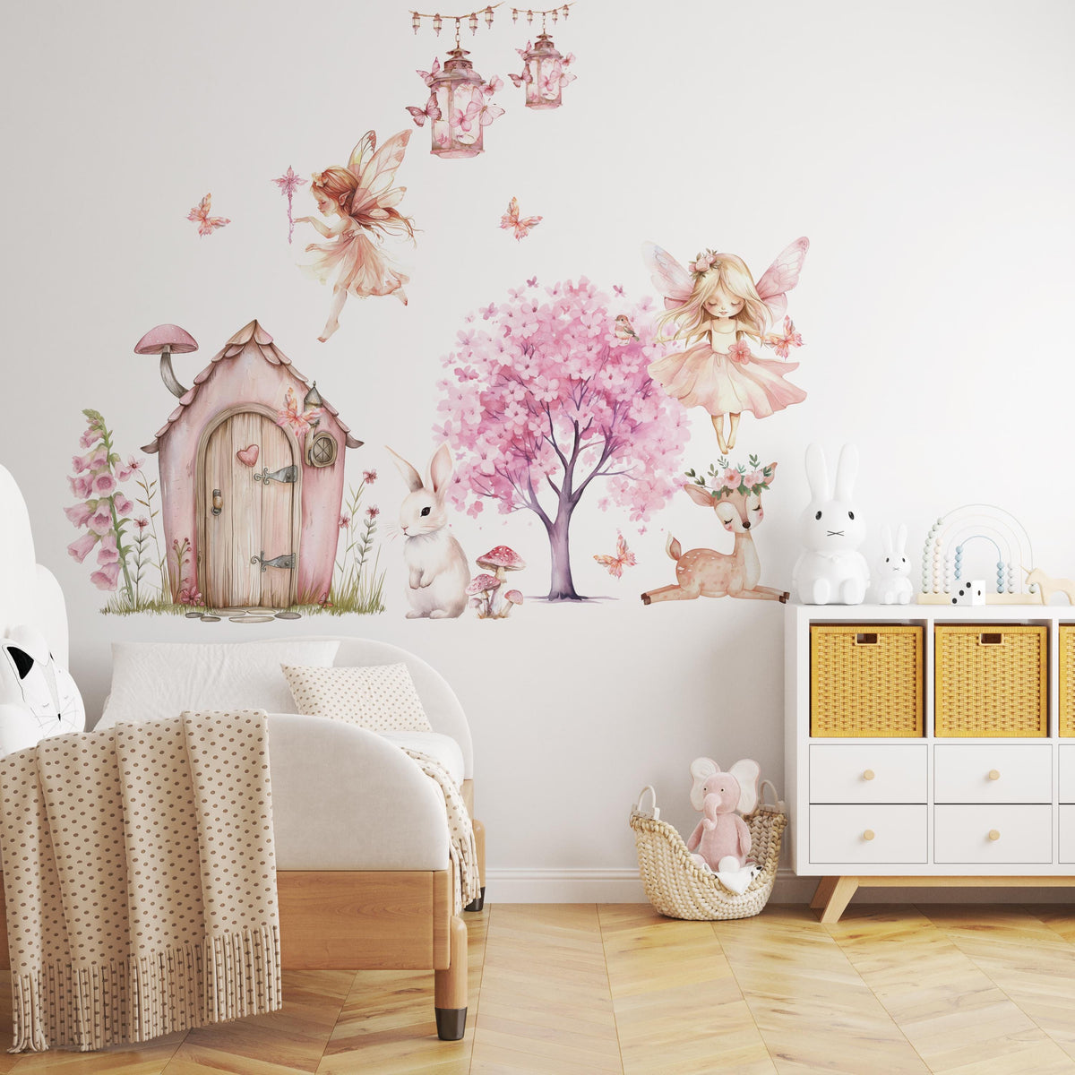 Fairy wall decals arranged around a bed and storage unit