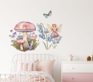 Kids room decals with a pastel fairy and a butterfly above a bed