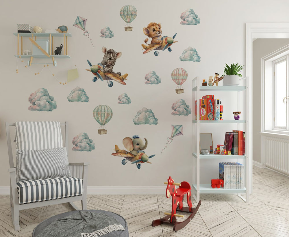Sweet African Animals in Flying Machines wall stickers – cute baby lion, elephant and zebra flying in airplanes among clouds, playful peel and stick nursery decor by Igibee