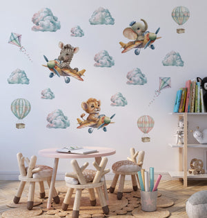 Adorable baby lion cub in flying machine wall sticker – sweet safari animal decal performing acrobatics in the sky, nursery safe by Igibee