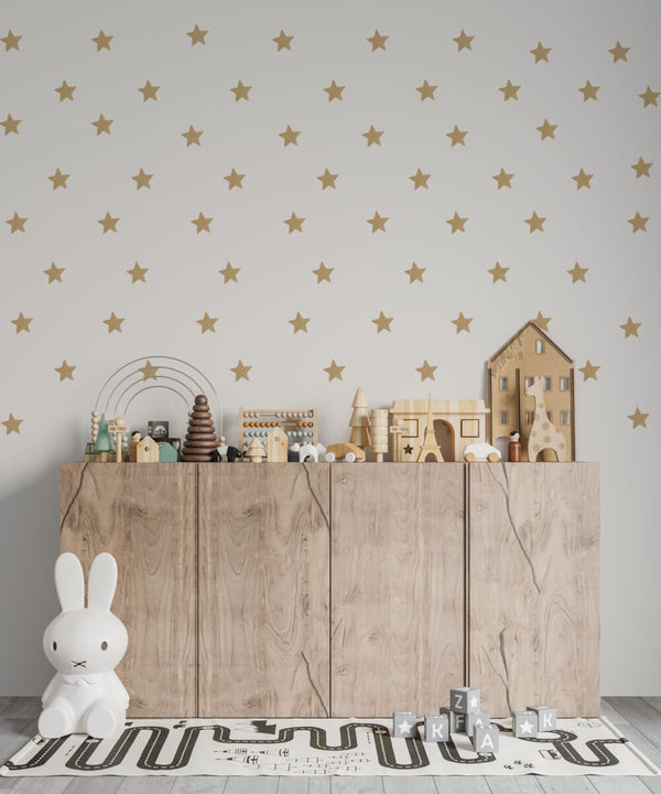 Nursery stickers with gold stars on a pastel wall
