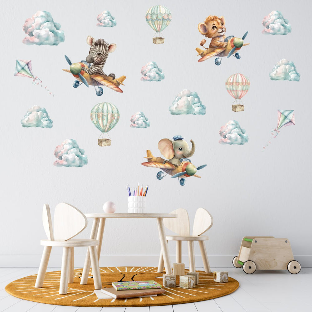 Sweet African Animals in Flying Machines wall stickers – cute baby lion, elephant and zebra flying in airplanes among clouds, playful peel and stick nursery decor by Igibee